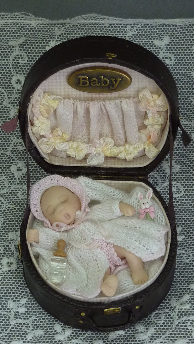 Baby doll in a hat box
